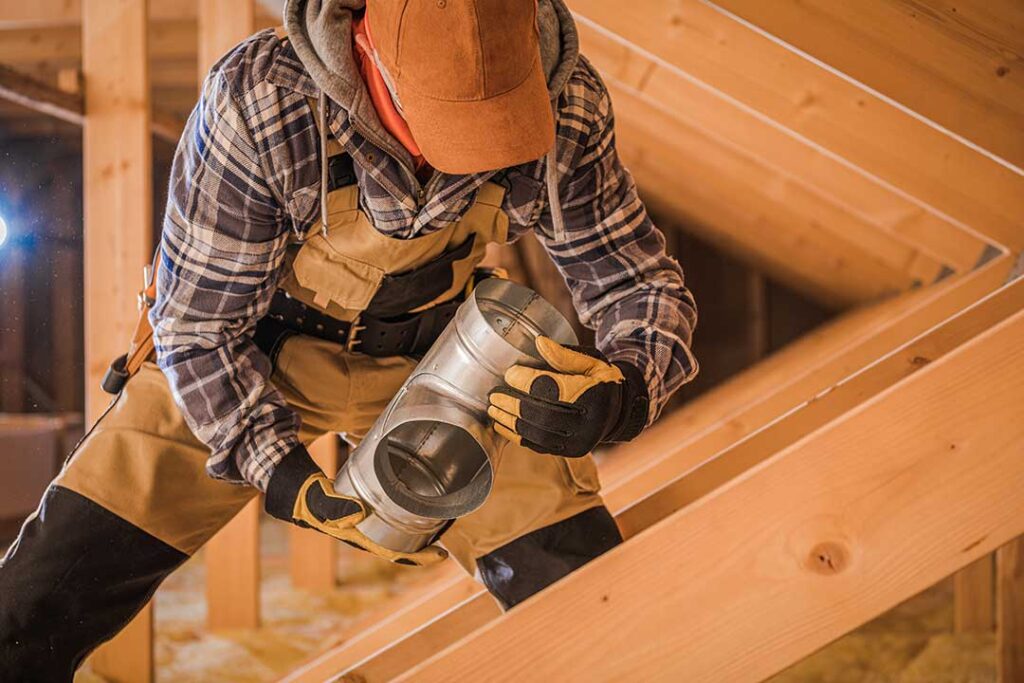A homeowner checking insulation and weatherstripping around a window inside a typical family home.