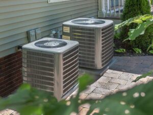 Homeowner checks a thermostat while a central air conditioner runs beside a dusty filter. KEYWORDS: ["central air conditioner troubleshooting", "frozen AC coil", "homeowner checking HVAC filter"]